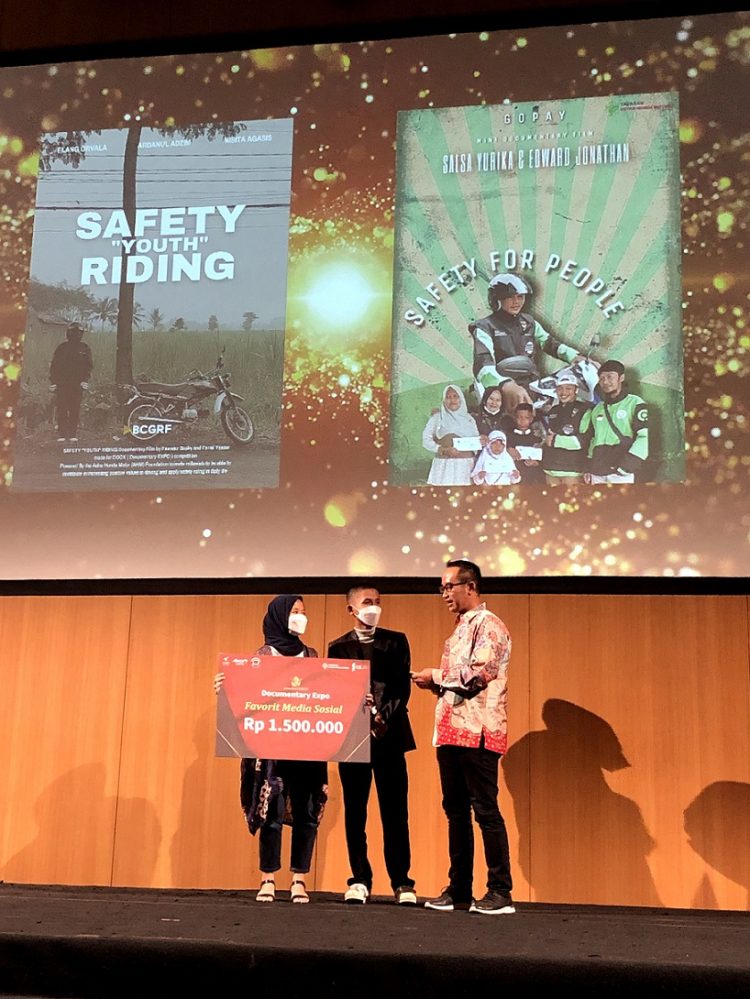 Ketua Yayasan AHM Ahmad Muhibbuddin memberikan hadiah kepada kreator film "Safety Youth Riding" pada malam awarding yang diselenggarakan di Kalbis Institute, Jakarta Utara (11/1/2023). (Foto Yayasan AHM)